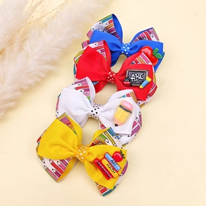 Lot de 4 barrettes nœuds rentrée scolaire avec motifs crayons et breloques papeterie