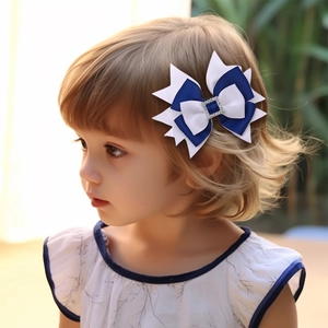 Detailed close-up of a blue and white layered bow hair clip with a rhinestone on a child