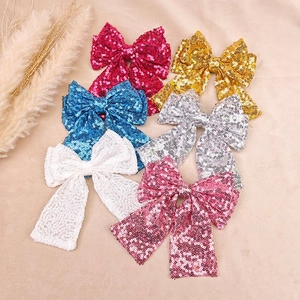 Detailed view of six colorful sequined bow hair clips for girls in a stylish set