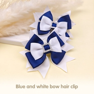 Detail of blue and white layered grosgrain bow hair clips with rhinestone center set of 2