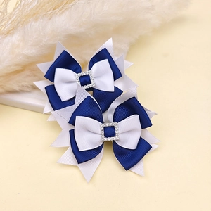 Detail of blue and white rhinestone bow hair clips on a stylish marble background