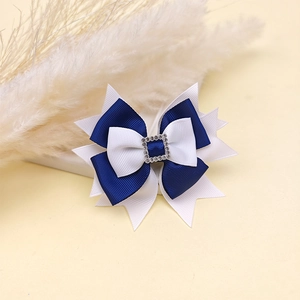 Detailed macro view of blue and white grosgrain ribbon hair clip with square rhinestone