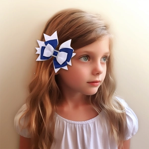 Close-up of blue and white layered grosgrain bow hair clip with rhinestone on girl