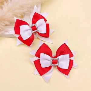 Detail of red and white grosgrain ribbon hair bows with sparkling rhinestone center