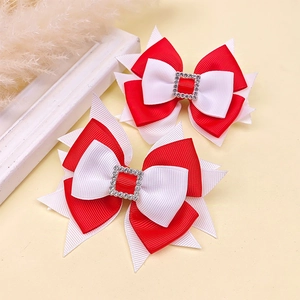Detailed view of red and white grosgrain ribbon bows with sparkling rhinestone buckles