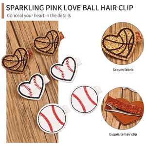 Sparkling pink heart and baseball sequin hair clips set for sports fans on wood surface