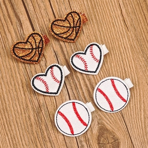 Detail view of 6-piece sequin sports hair clips with basketball and baseball heart motifs