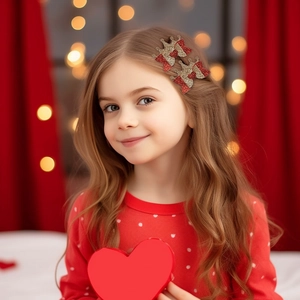 Close-up of glitter crown hair clips with red bows on a little girl for festive occasions