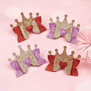 Detail of red and purple glitter crown hair clips for girls with sparkling finish