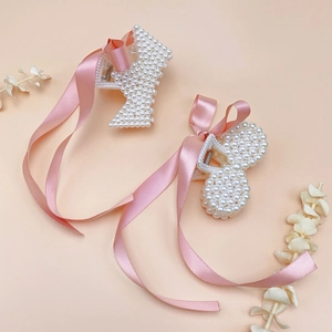 Kids pearl hair clips set with P-shape and bow designs featuring long pink ribbons