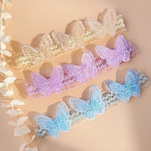 Three elastic lace baby headbands with champagne, lilac, and blue butterfly embroidery