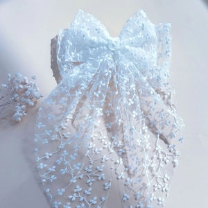 Elegant white embroidered lily of the valley lace hair clip accessory with mesh bow