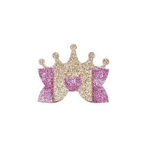 Detail view of glitter crown hair clip with bow and heart for girls' hair styling