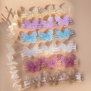Detail of six lace baby headbands with delicate embroidered butterflies in various pastel colors