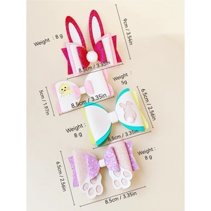 Detailed view of glitter Easter hair clips with rabbit ears and chick designs including sizes