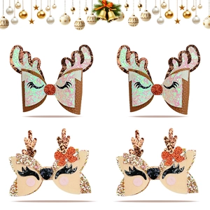 Detailed close-up of Christmas reindeer bow hair clips with glitter antlers and sequins