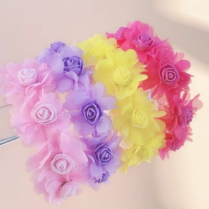 Detailed macro view of four colorful floral headbands featuring layered tulle petals and sequins
