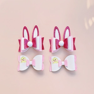 Detailed set of 4 Easter hair clips with bunny ears and cartoon chick bow designs