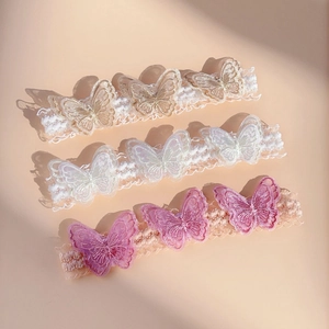 Detailed embroidery on three-piece lace butterfly headbands for babies in soft colors