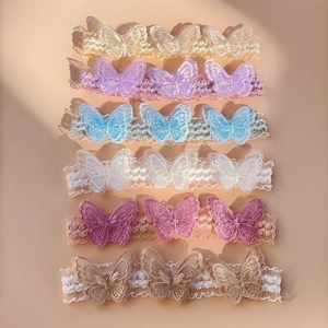 Close-up of elastic lace baby headbands with delicate double-layered butterfly embroidery