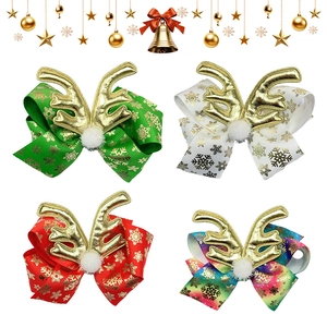 Christmas bow hair clips with golden antlers and snowflake patterns in various colors