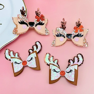 Detailed set of 4 glittery reindeer antler bow hair clips for girls' Christmas celebration