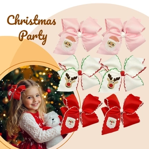 Detailed view of 6-piece Christmas hair clips set with Santa and reindeer embroidery