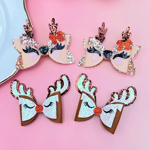 Detail of Christmas reindeer bow hair clips with glitter sequins and elk horn design