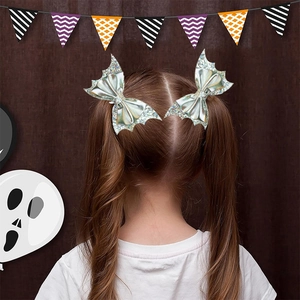 Silver glitter bat wing hair clips for girls worn on twin ponytails for Halloween party
