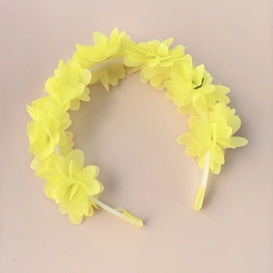 Detailed view of yellow floral headband with layered chiffon flowers for girls