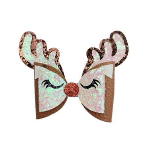 Close-up of glitter reindeer antler bow with brown leather and pink sequins