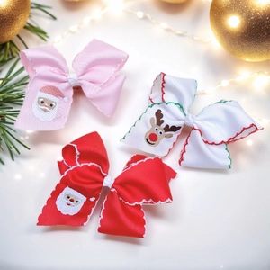 Three-piece Christmas bow hair clips featuring embroidered Santa and reindeer patterns