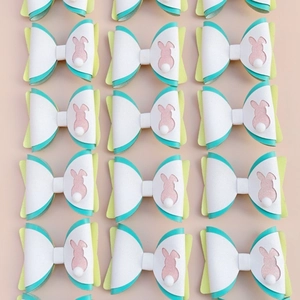 Flat lay of multiple Easter rabbit ear bow hair clips with glitter and faux leather