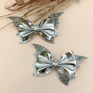 Detail of silver sequin bat wing bow hair clips for girls' Halloween party accessories
