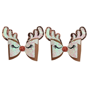Detailed close-up of Christmas reindeer hair clips with glitter antlers and sequin nose