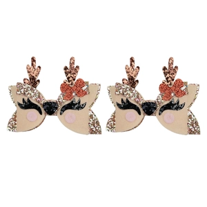 Detail of Christmas reindeer hair clips with glitter antlers and red sequin bows
