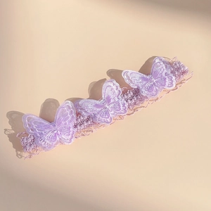 Macro view of purple lace butterfly headband with delicate embroidery and tiny bead accents