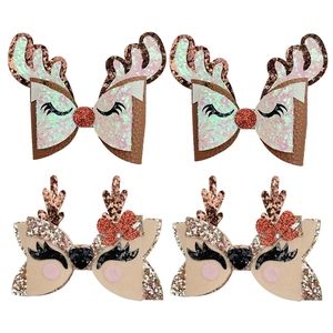 Detail of glitter Christmas reindeer hair clips with sequin antlers and felt ears