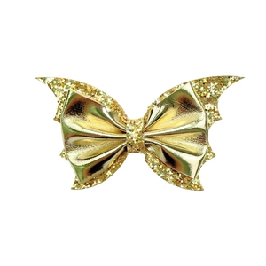 Detailed view of multilayered gold sequin bat wing hair clip for Halloween party
