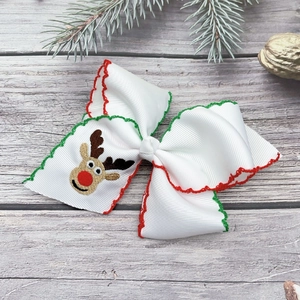 Detail view of handmade Christmas hair clip with reindeer embroidery and festive ribbon