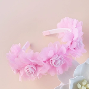 Detailed side view of a pink tulle flower headband for girls featuring rose petal accents
