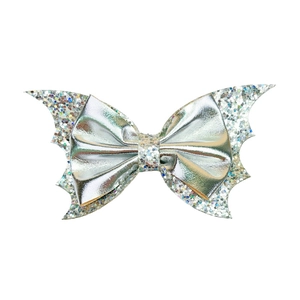 Detailed view of silver glitter bat wing hair clip with bow for Halloween party costume