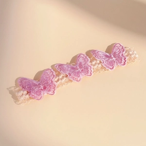 Detail of baby lace headband with three pink 3D embroidered butterflies and elastic band