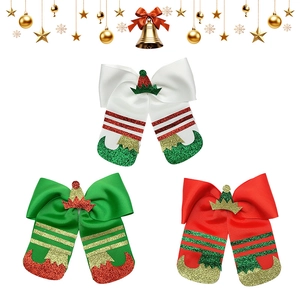 Three Christmas elf-themed hair bows with glitter hats and boots in red, green and white