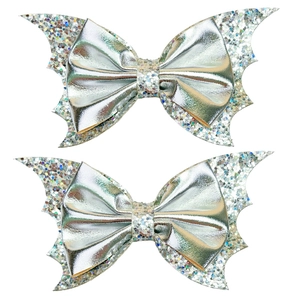 Close-up of Halloween bat wing hair clips with silver bow and colorful sequins