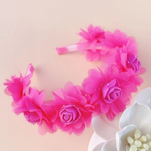 Close-up detail of rose red tulle flower headband with soft pink satin wrap