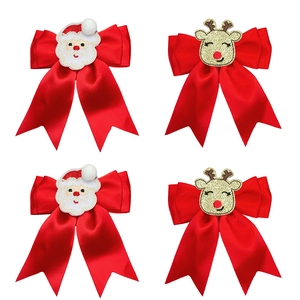 Christmas hair clips set with red bows featuring embroidered Santa and reindeer patterns