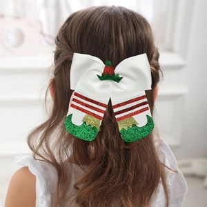 Detail of Christmas elf boot hair clip with green glitter on a girl's hairstyle
