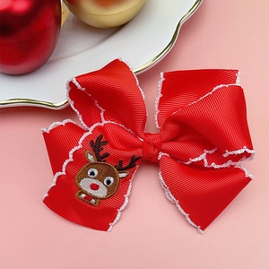 Detail of red Christmas ribbon bow hair clip featuring exquisite elk embroidery