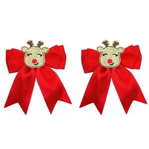 Detailed view of red bow hair clips with gold glitter reindeer for Christmas holidays